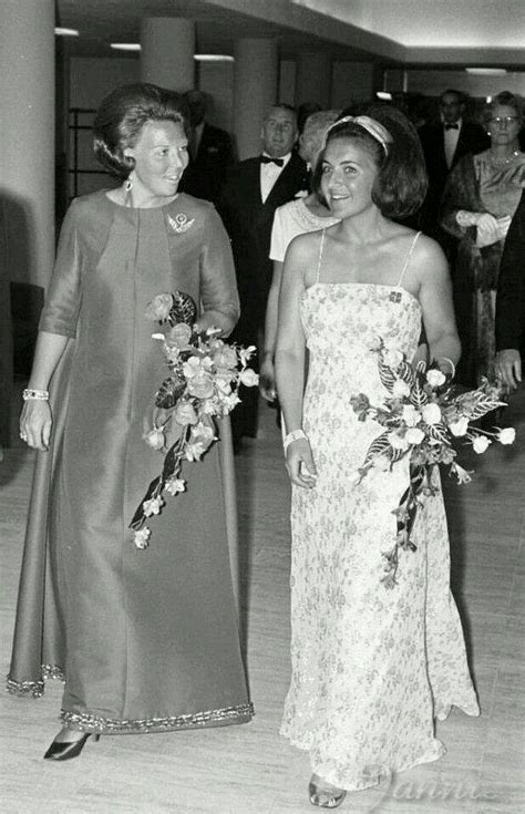 Black And White Photograph Of Two Women In Formal Wear Standing Next To