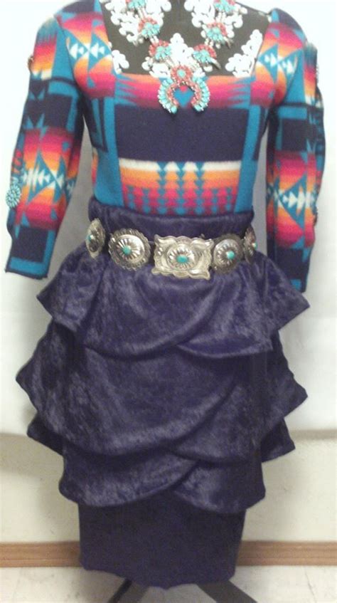 A Mannequin Wearing A Colorful Dress And Belt