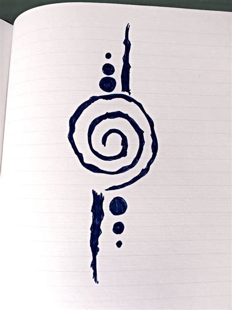 An Open Notebook With Black Ink On It And A Spiral Drawn In The Middle