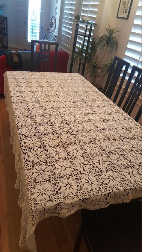 A White Table Cloth On Top Of A Wooden Table