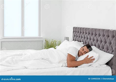 Young Man Sleeping in Bed with Soft Pillows Stock Photo - Image of ...