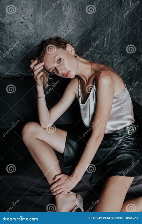 Portrait Of A Beautiful Fashionable Blonde Woman In A Black Skirt Stock