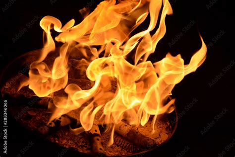 Fire Flame On A Black Background Burning Passion Phenomenon Of Combustion Manifested In Light