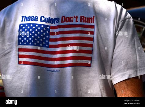 A Man Wears A T Shirt Imprinted With The American Patriotic Phrase