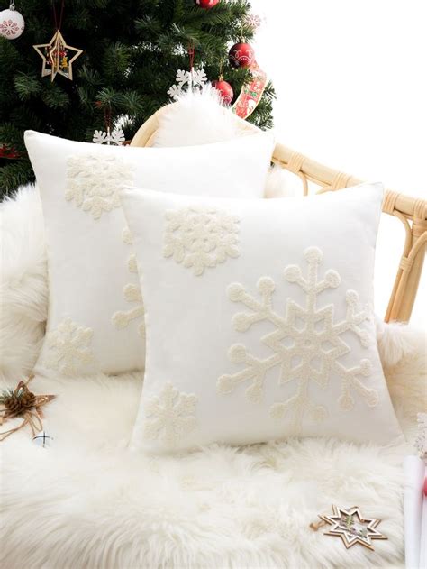 Two White Pillows Sitting Next To A Christmas Tree