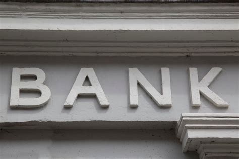 Premium Photo | Bank sign over building entrance