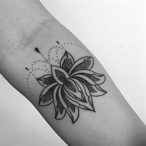 A Black And White Photo Of A Flower Tattoo On The Left Arm With Dots