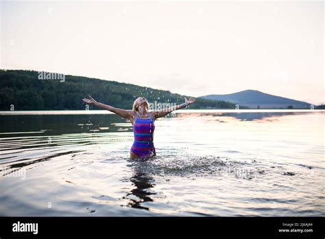 Portrait Of Active Senior Woman Swimmer Standing And Stretching