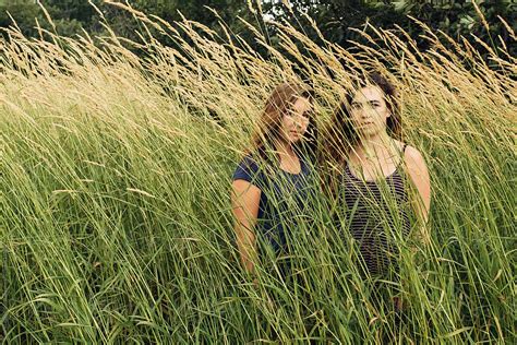 Two Teens Behind Tall Grass By Stocksy Contributor Gabi Bucataru