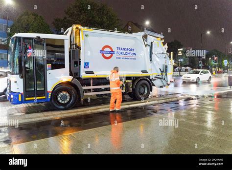 Waste Management Truck And Driver Working At Night For London Transport