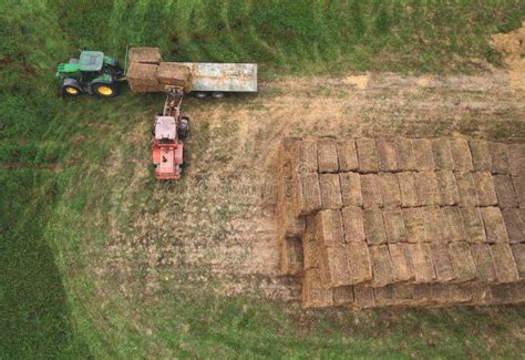 Loader At Unload Round Bales Of Straw From Hay Trailer Store Hayat