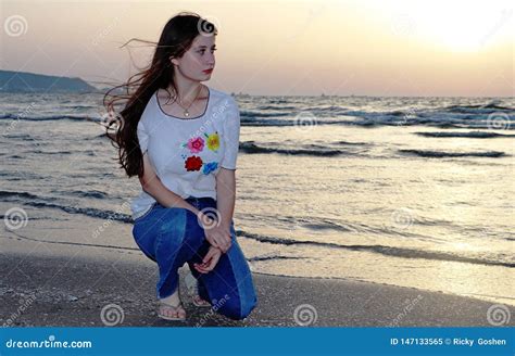 Um Adolescente Bonito Senta Se Na Praia Imagem De Stock Imagem De