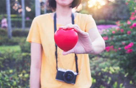 Premium Photo Midsection Of Woman Holding Pink Flower