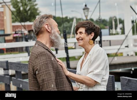 Happy Senior Woman Hugging Man Looking At Each Other Outdoors Love