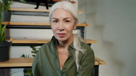 Slow Motion Portrait Of Beautiful Mature Lady Sitting On Stairs At Home