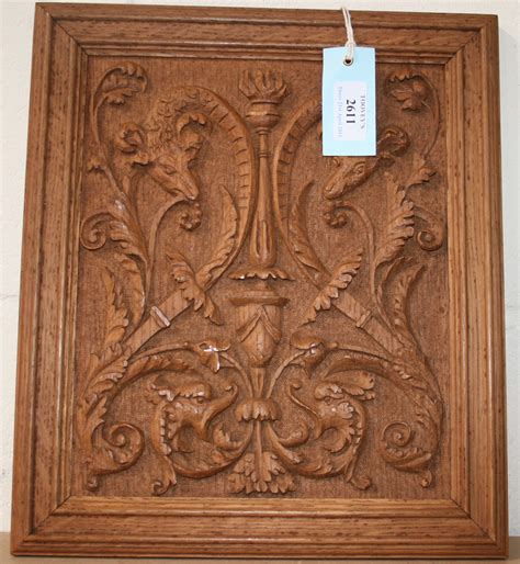 An Early 20th Century Carved Oak Panel Decorated In Relief With Foliate Scrolls And Ram Masks With