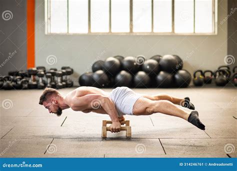 Sportsman Doing Bent Arm Straddle Planche Calisthenics Exercise Stock