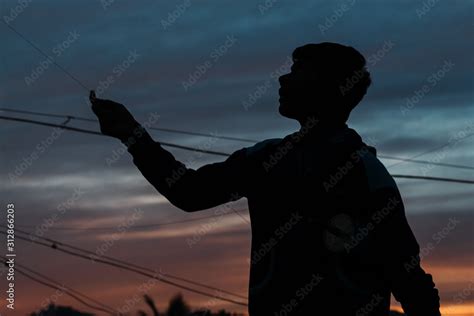 Silhouette of a little kid flying kite during sunset Stock Photo | Adobe Stock