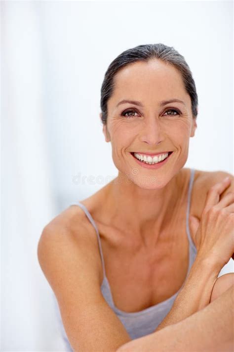 Happy And Healthy Cropped Portrait Of A Beautiful Mature Woman Posing