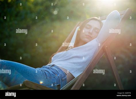 Young Woman Sleeping On Chair In Park Stock Photo Alamy