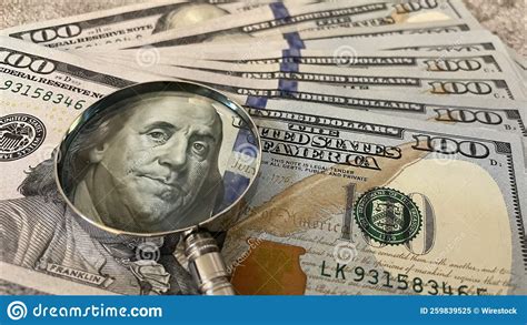 Closeup Of A Pile Of American Dollar Banknotes Under A Magnifying Glass