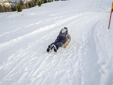 wooden sledge on the snow in dolomites 12012798 Stock Photo at Vecteezy