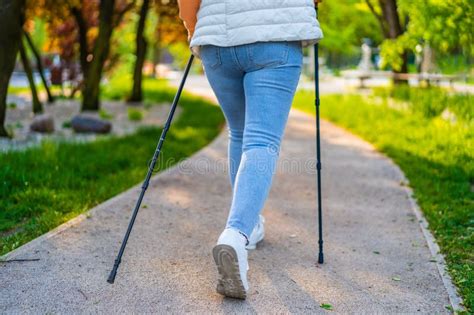 Nordic Walking Mature Woman Exercising In City Park Stock Photo