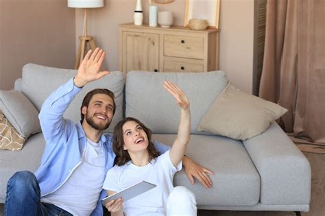 Premium Photo Happy Couple Sitting And Planning New Home Decoration At Home With A Tablet