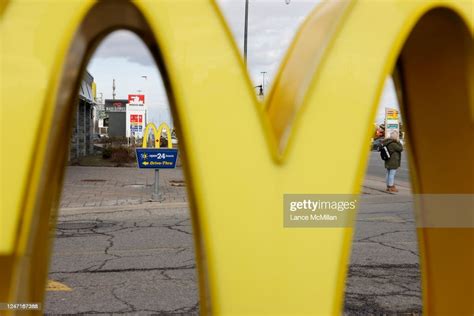 A Person Is Pictured Behind The Mcdonalds Golden Arches Outside The