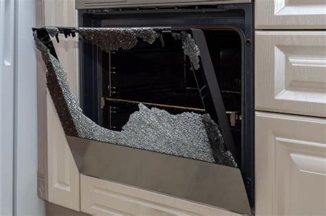 Premium Photo Opened Broken Oven Door In The Kitchen Side View Closeup Broken Glass From