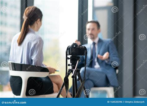 Camera Filming Businessman Giving Interview To Famous Journalist Stock