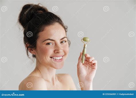 Half Naked Brunette Woman Smiling While Showing Jade Roller Stock Image