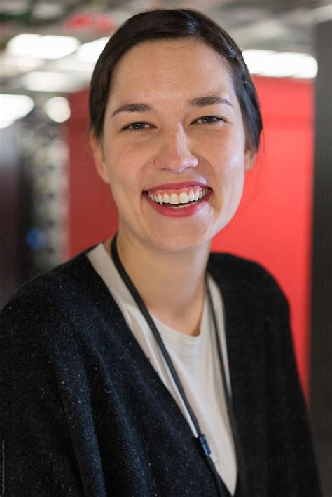 Portrait Of An Ethnic Server Room Technician Smiling Warmly By