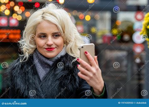 Young Beautiful Blonde Woman Taking Selfies Against The Background Of