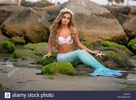 Beautiful Mermaid On Rocky Beach Stock Photo Alamy