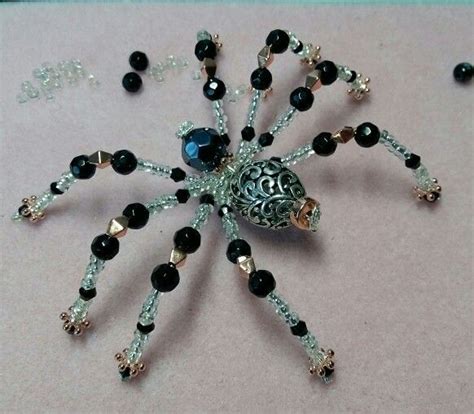 Beaded spider with a hint of steampunk | Wire work jewelry, Beaded spiders, Spider jewelry