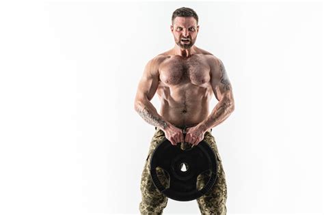Premium Photo Muscular Athlete Bodybuilder Man In Camouflage Pants With A Naked Torso Workout