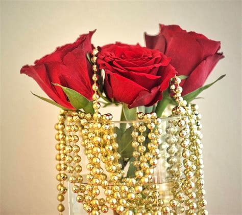 Premium Photo A Vase Of Red Roses Is Filled With Gold Beads