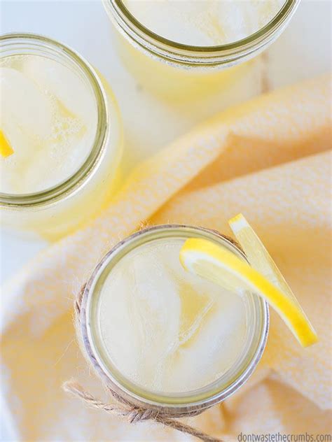 Two Mason Jars Filled With Lemonade Sitting On Top Of A Yellow Towel