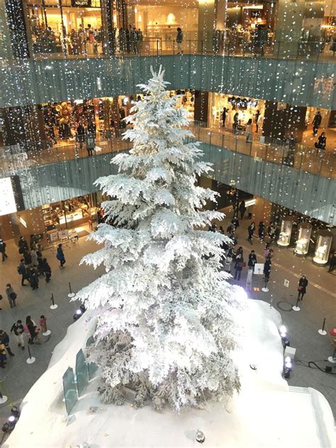 A Large White Christmas Tree In The Middle Of A Mall