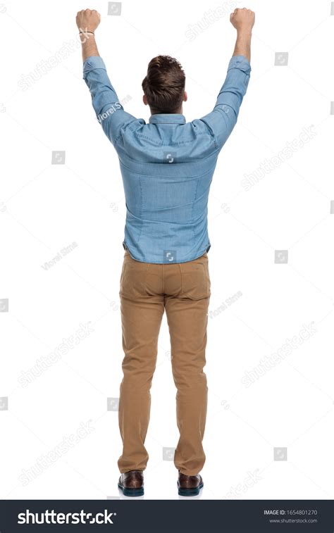 Rear View Celebrating Casual Man Standing Stock Photo