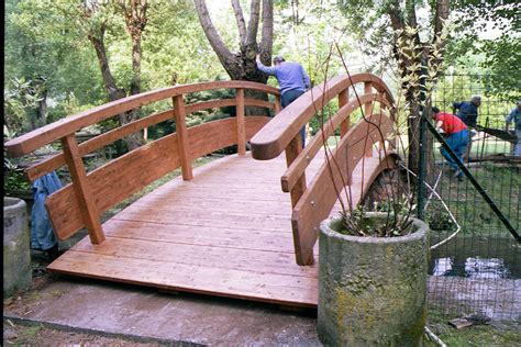 A Wooden Bridge In The Middle Of A Park