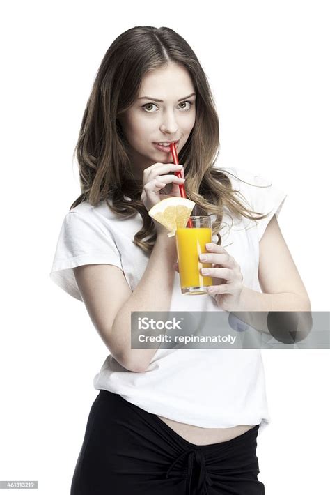 Young Beautiful Brunette Woman Holding Glass Of Orange Juice Stock