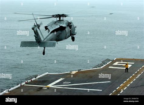 Us Navy An Mh 60s Seahawk Helicopter Assigned To The Blackjacks Of