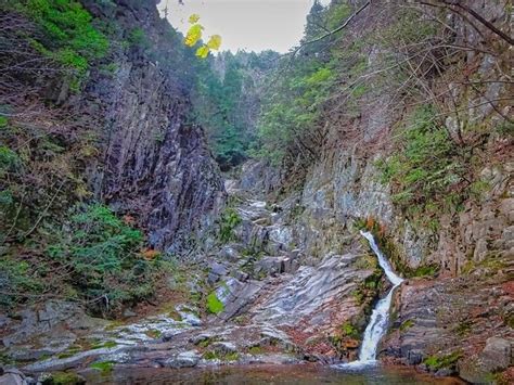 There Is A Small Waterfall In The Middle Of This Mountain Side Area