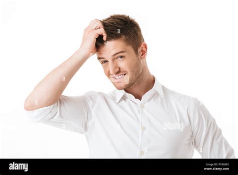 Portrait Of A Confused Young Man Scratching His Head Isolated Over