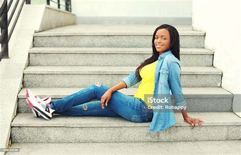 Beautiful African Woman Wearing Jeans Clothes Sitting Resting On Stairs