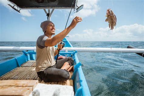 An Angler Is Happy When He Catches A Fish Stock Image Image Of Angler