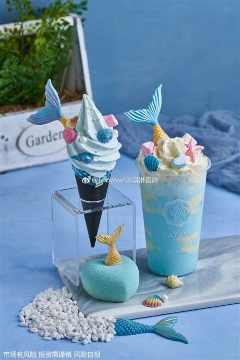 Two Ice Cream Sundaes On A Blue Table With Sea Shells And Mermaid Tail