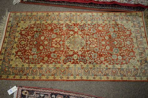 Lot 138 - A Persian silk carpet